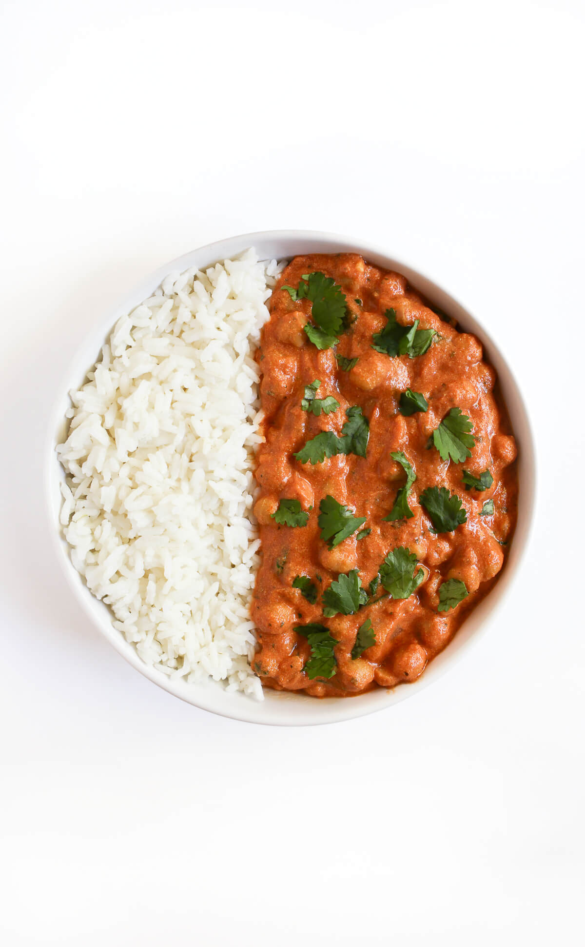 serving bowl with white rice and vegan chickpea tikka masala.