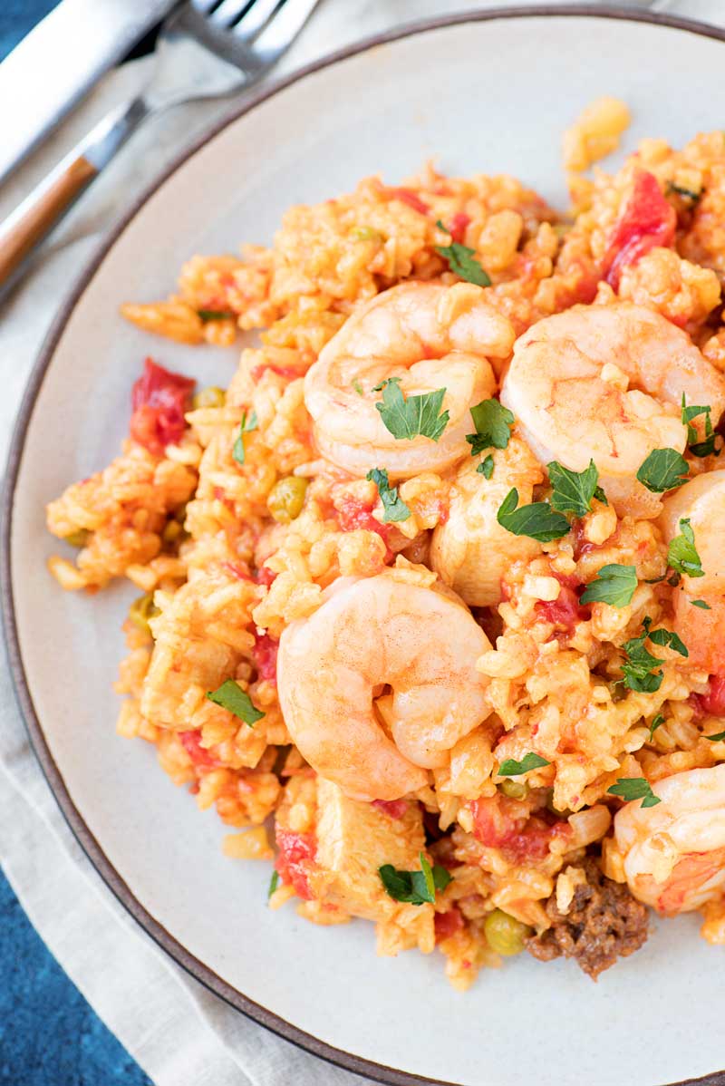 Spanish Chorizo, Shrimp, and Chicken Paella! A simple paella recipe made with chorizo, shrimp, and chicken and cooked with tomatoes, veggies, and yellow rice. It's a great one-pot meal for weeknights! #ad #vigotakesyouhome | HomemadeHooplah.com