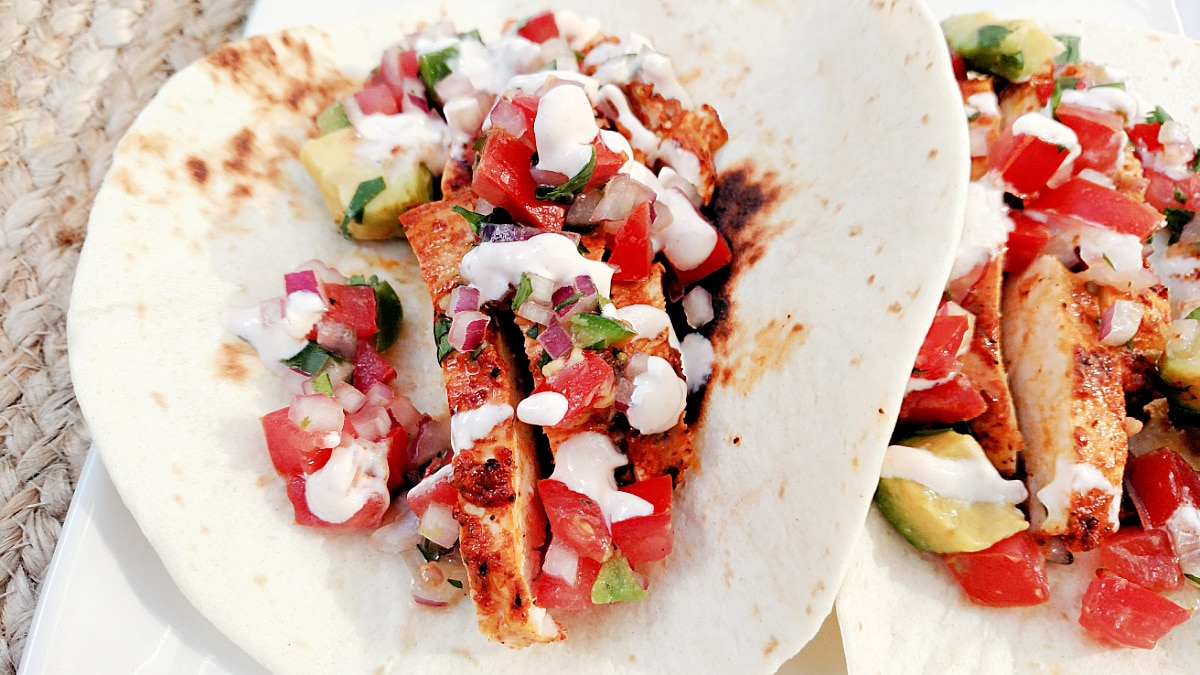 A close up of Achiote Chicken Tacos with Creamy Chipotle Sauce.