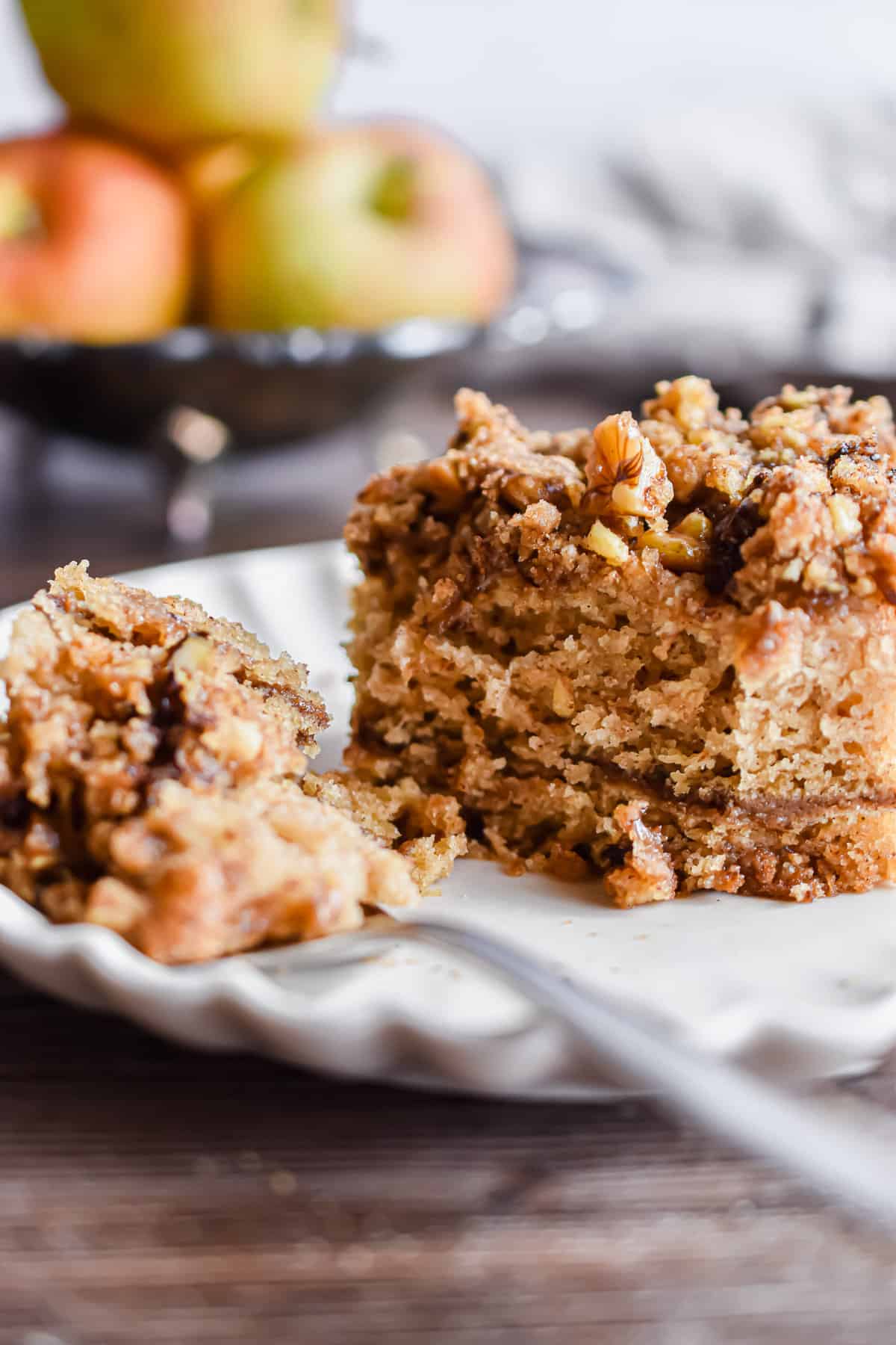 A close up of a slice of cake and a piece on the fork.
