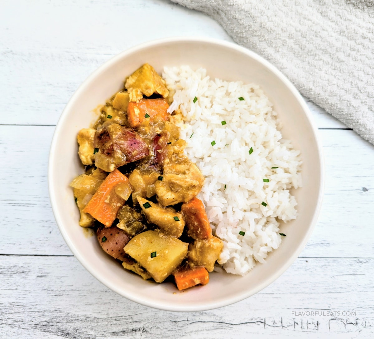 Slow Cooker Japanese Chicken Curry in a white bowl with rice.