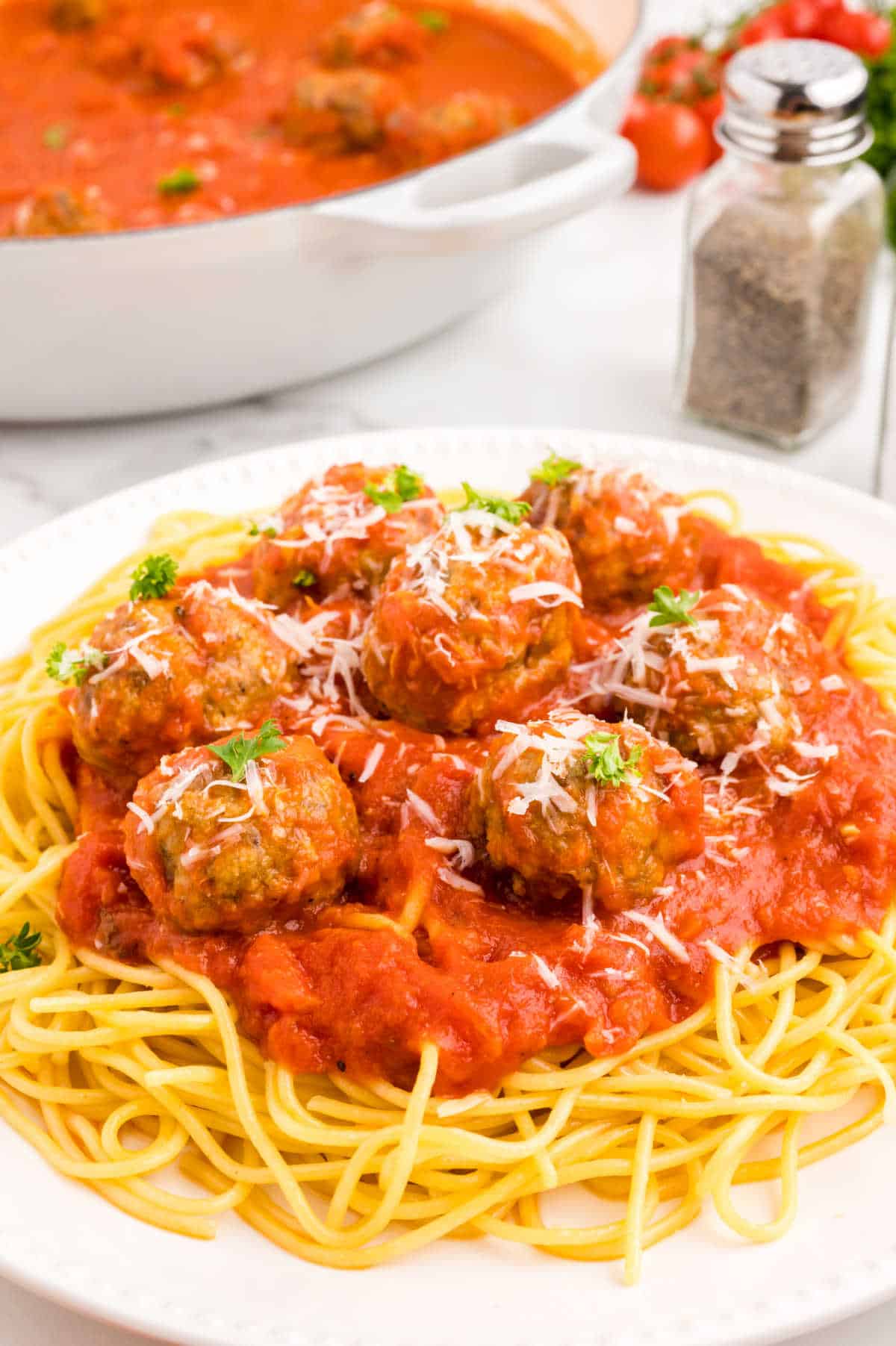 Italian meatballs with marinara sauce on a bed of spaghetti.