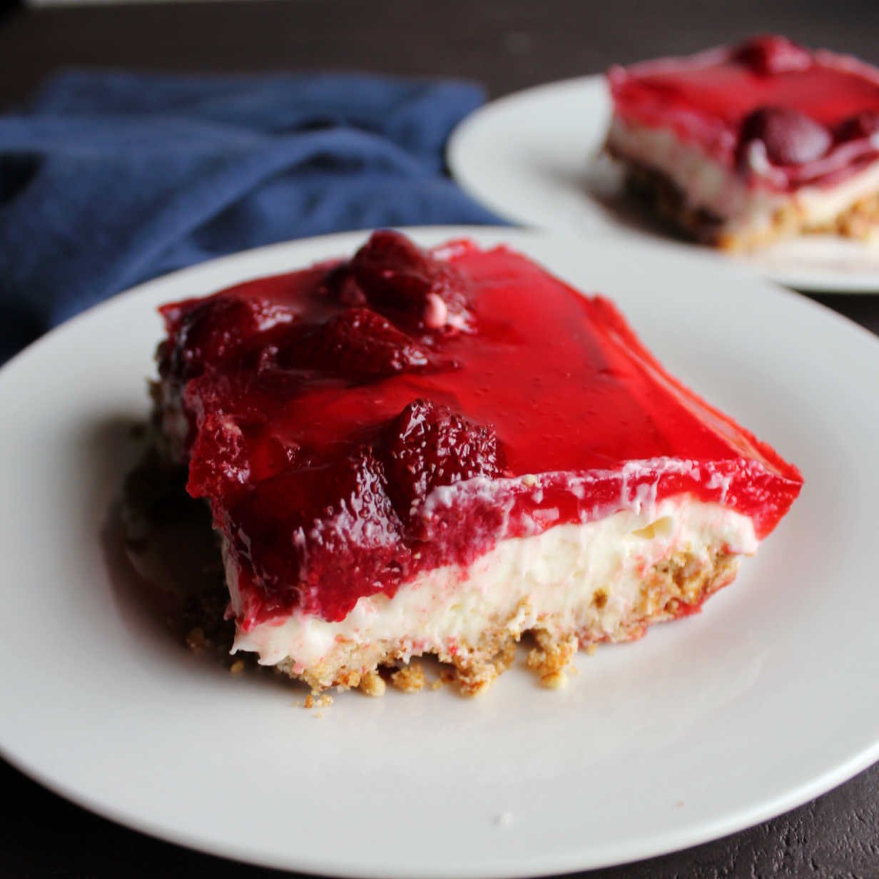 slices of strawberry jello pretzel salad ready to eat.
