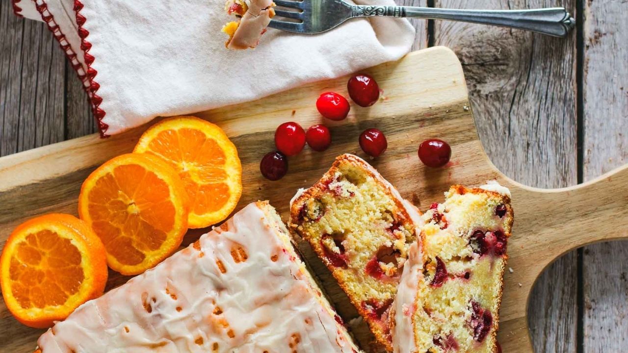 A glazed loaf of sourdough orange cranberry quick bread