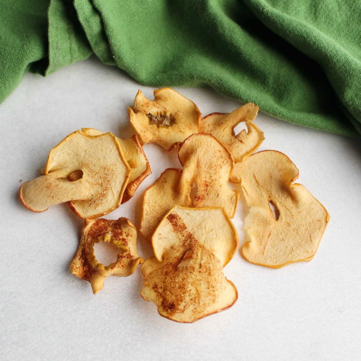 pile of homemade oven baked cinnamon sugar apple chips.