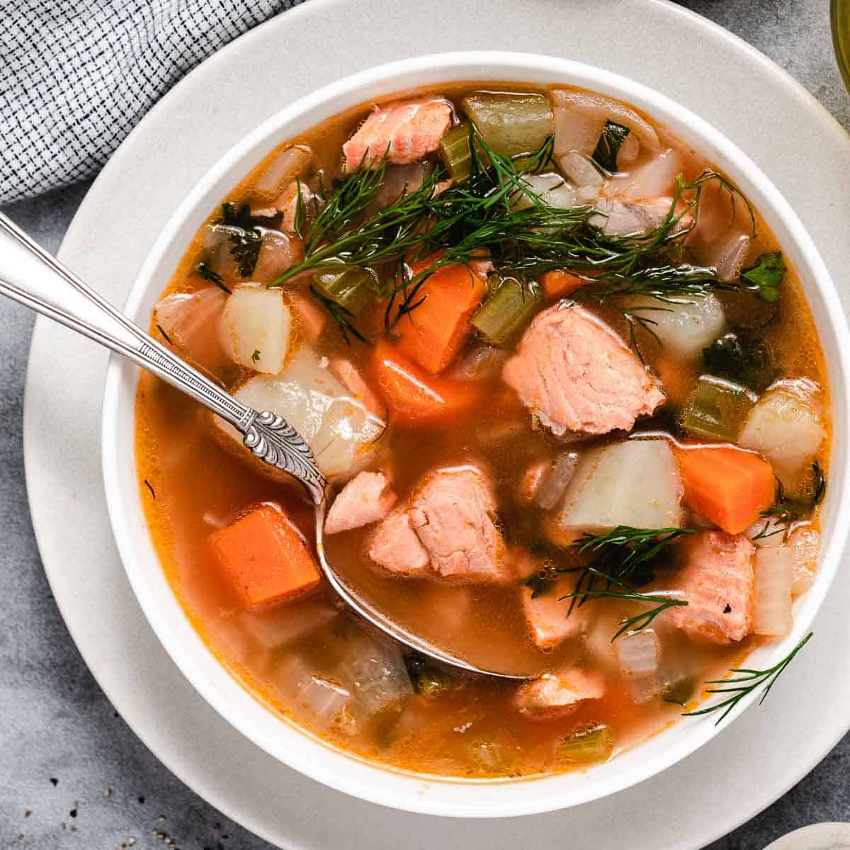 Salmon chowder in a white bowl.