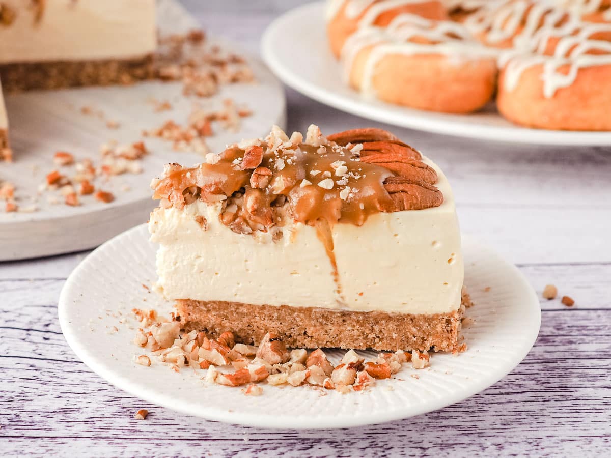 Caramel pecan cheesecake topped with glossy pecans.