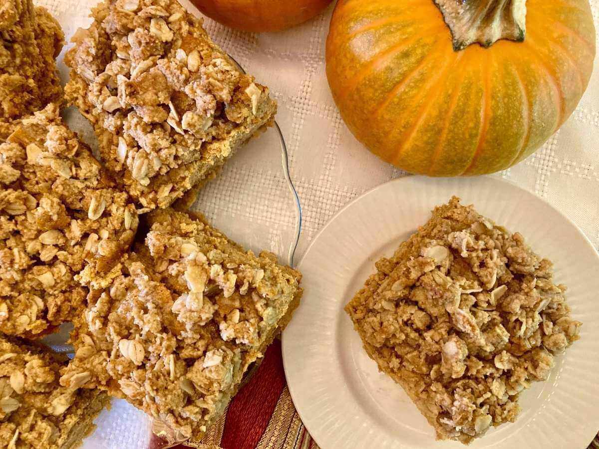 Pumpkin cheesecake bars cut into squares.