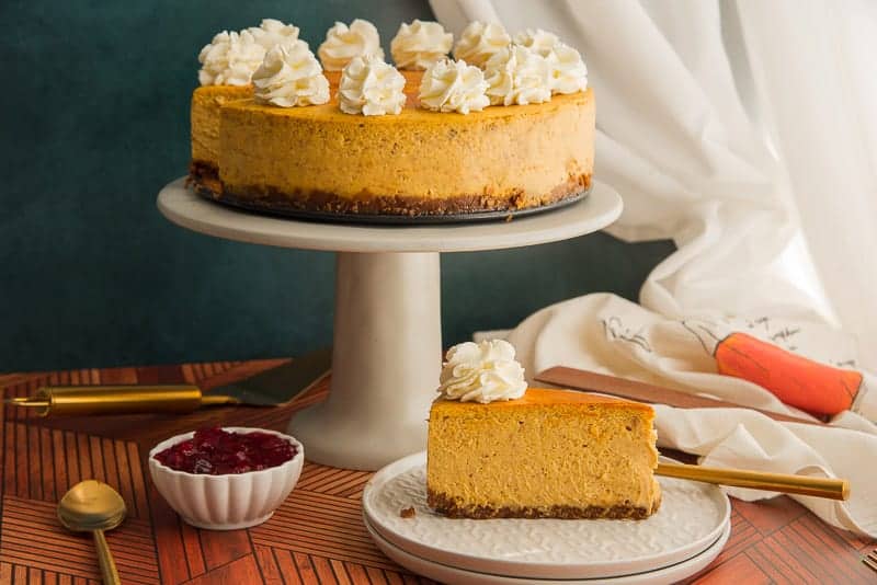 Pumpkin cheesecake with gingersnap crust and whipped topping.